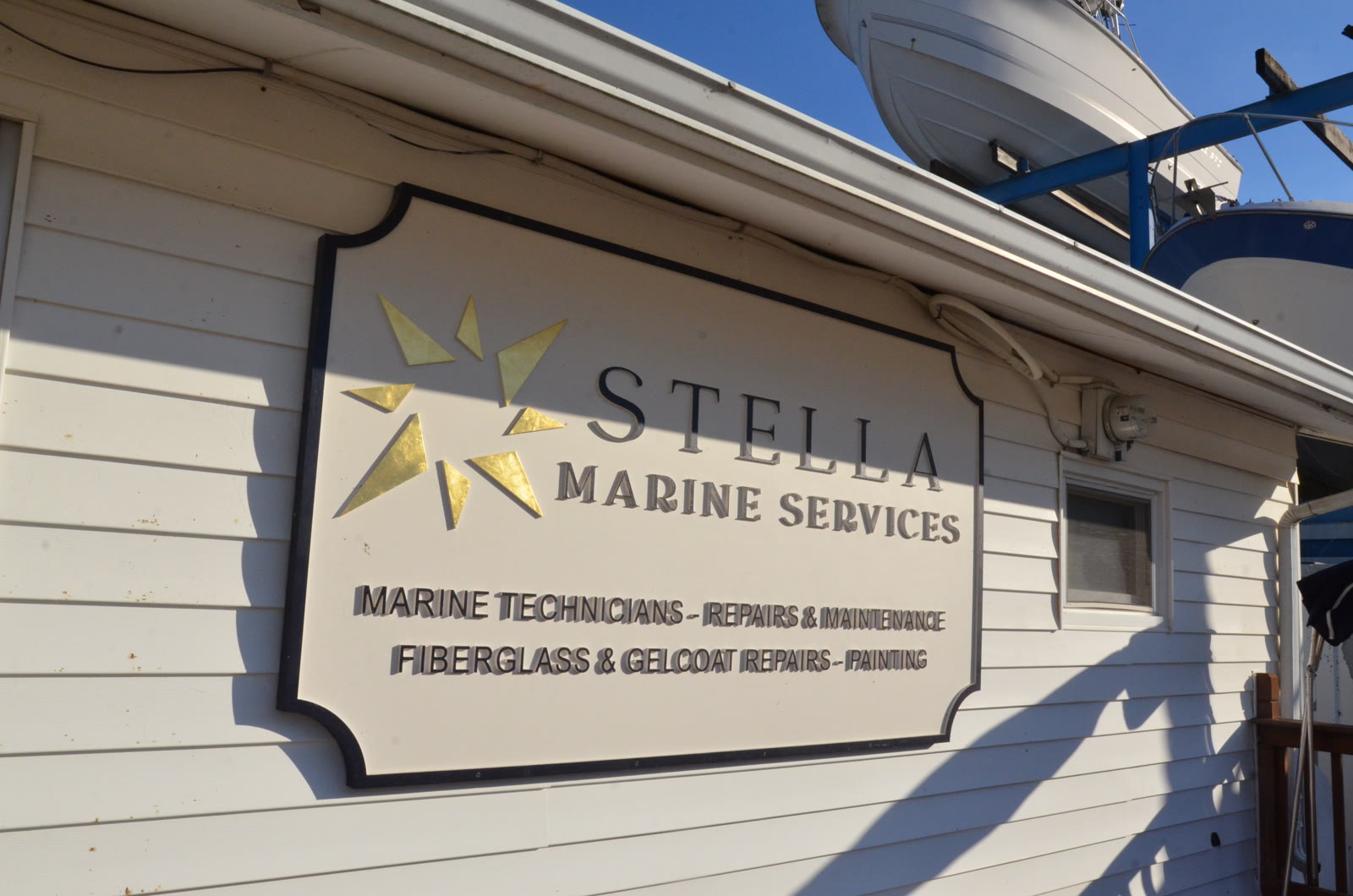 Stella Marine Services sign: marine technicians, repairs and maintenance, fiberglass and gelcoat repairs, painting